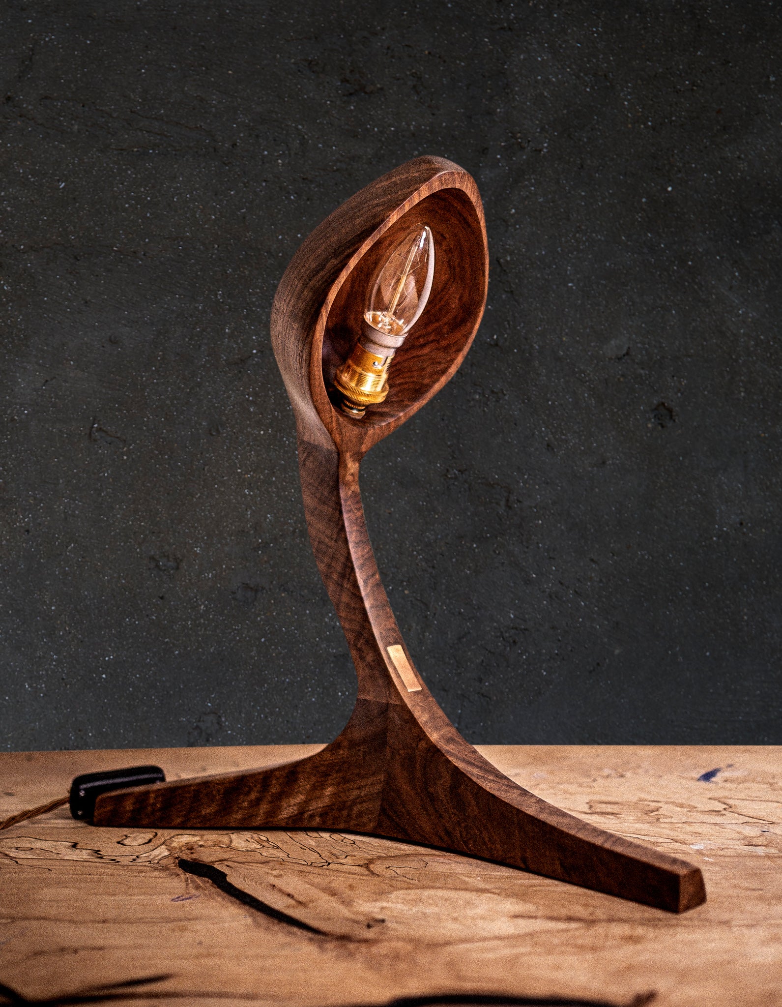 Live Edge Lamps. Looking for a unique and stylish wooden table lamp to light up your space? Our carefully handmade sculpted lamps are organic wooden art masterpieces made from amazing stock, in Black Walnut Wood, which is incredibly detailed and striking. A perfect addition to your home decor. The curved shapes of the wood carvings are stylish and add an original flavour to any interior. These are a one-of-a-kind high quality wood designer lamps made by our talented artisans.