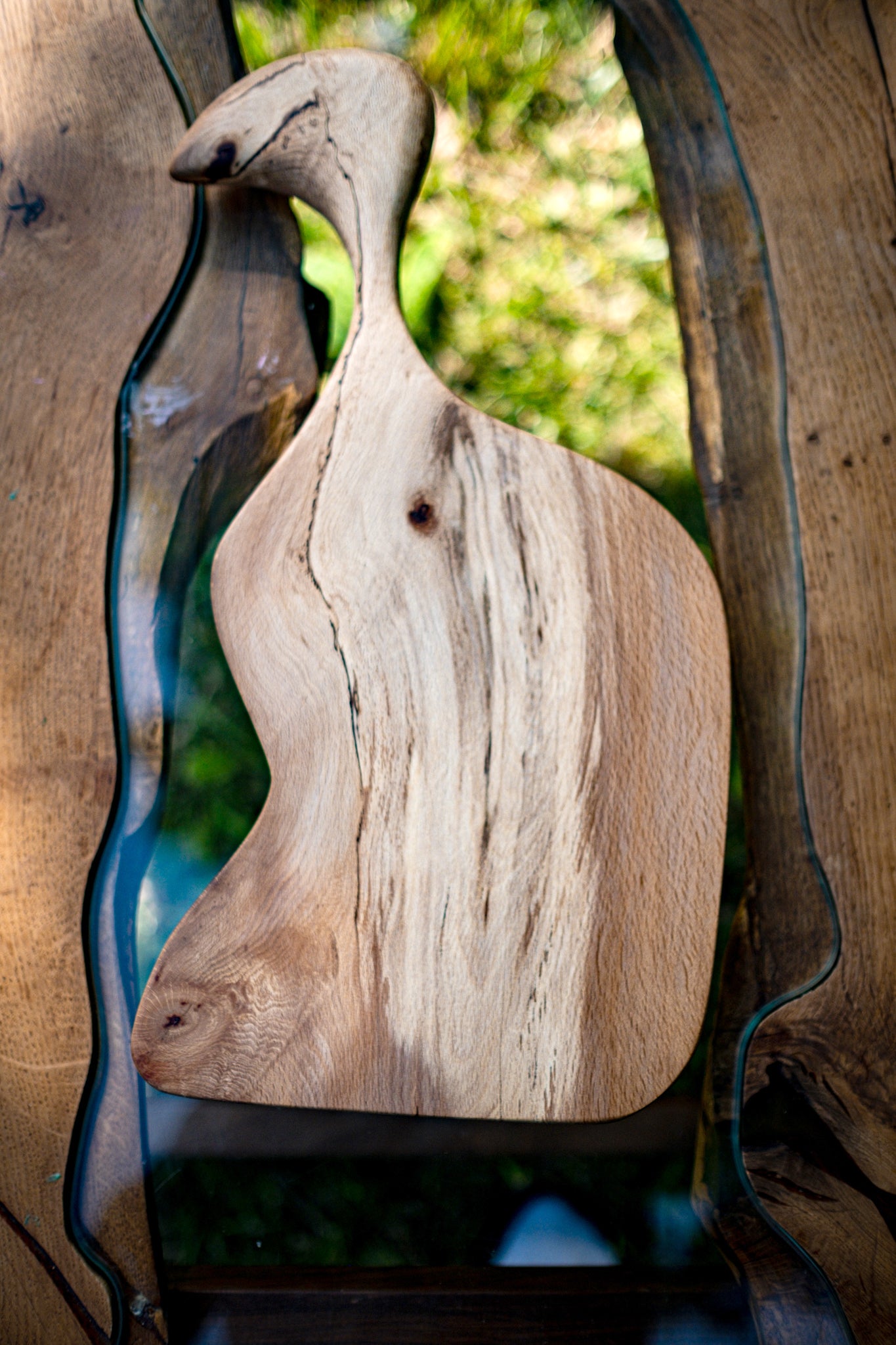 Introducing L'Oiseau, a one-of-a-kind deli tray that seamlessly blends functionality with artistry. This stunning wood sculpture is meticulously crafted from the finest wood, boasting a Live Edge finish that adds a touch of natural beauty. With its unique and whimsical design, featuring a charming bird-like head, L'Oiseau elevates your dining experience to a new level.
