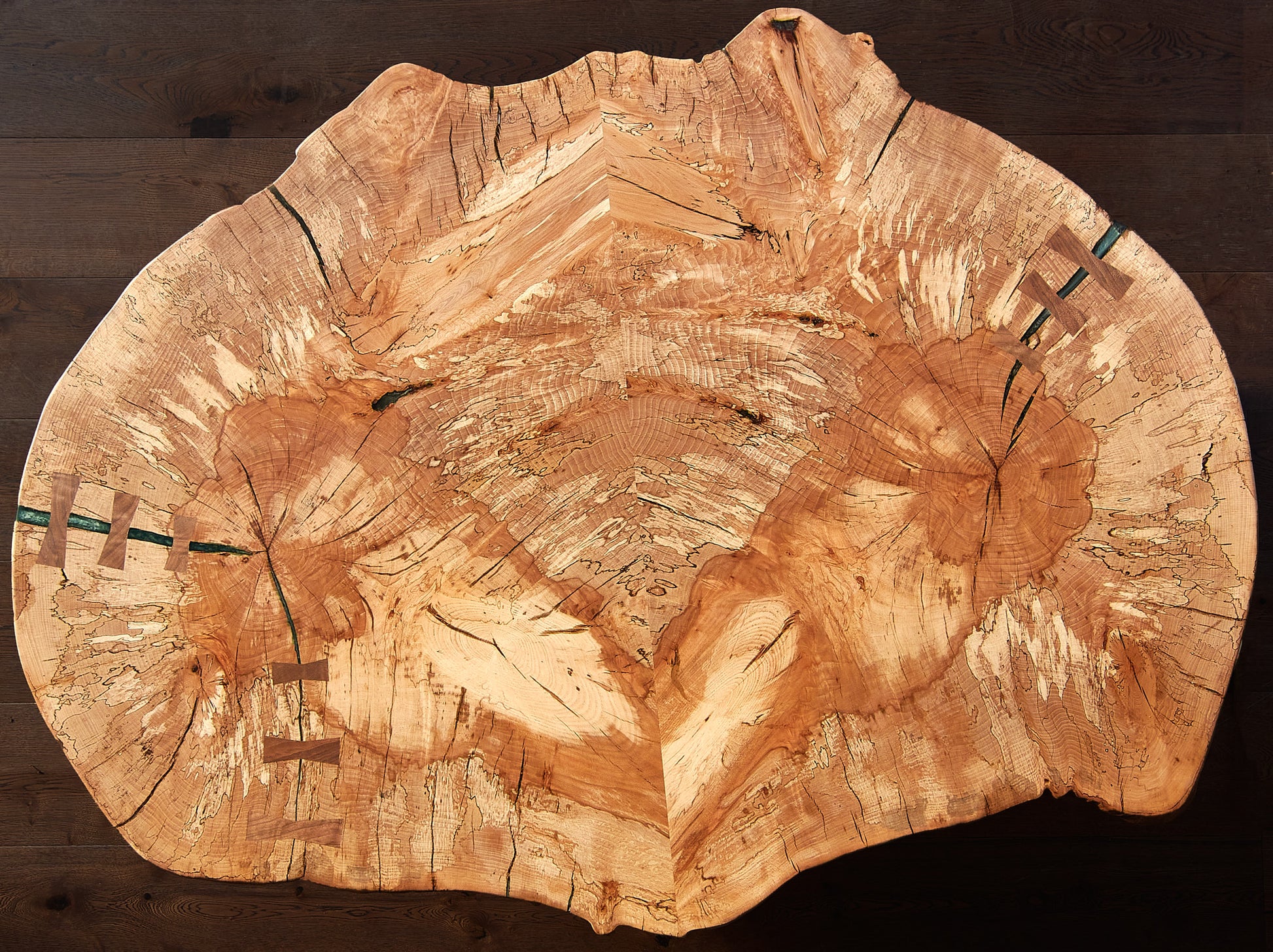 Introducing the 'Cocoon Coffee Table' by Live Edge Tables. This coffee table is a stunning showcase of the spalted beech Live Edge wood grain, infusing your space with a delightful blend of organic and rustic charm. It's more than just a stylish piece; it also offers functionality with a solid wood slab that exhibits an exquisitely detailed pattern achieved through expert book-matching joinery techniques.