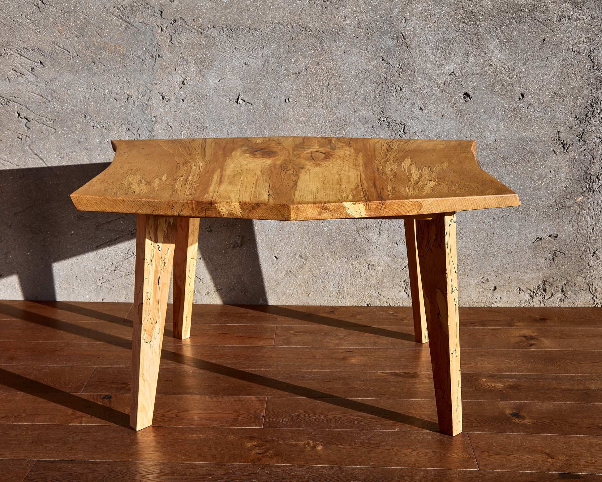 Behold the Moff Dining Table, a magnificent piece of Live Edge functional art. Constructed from spalted beech, this natural edge table features a remarkably detailed pattern that is simply unparalleled. The marriage of mid-century modern legs with the intricately book-matched tabletop gives this solid wood dining table a wealth of character. Its natural wax finish adds a beautiful, glossy touch. Expect this table to claim the spotlight in any room and offer years of enjoyment.