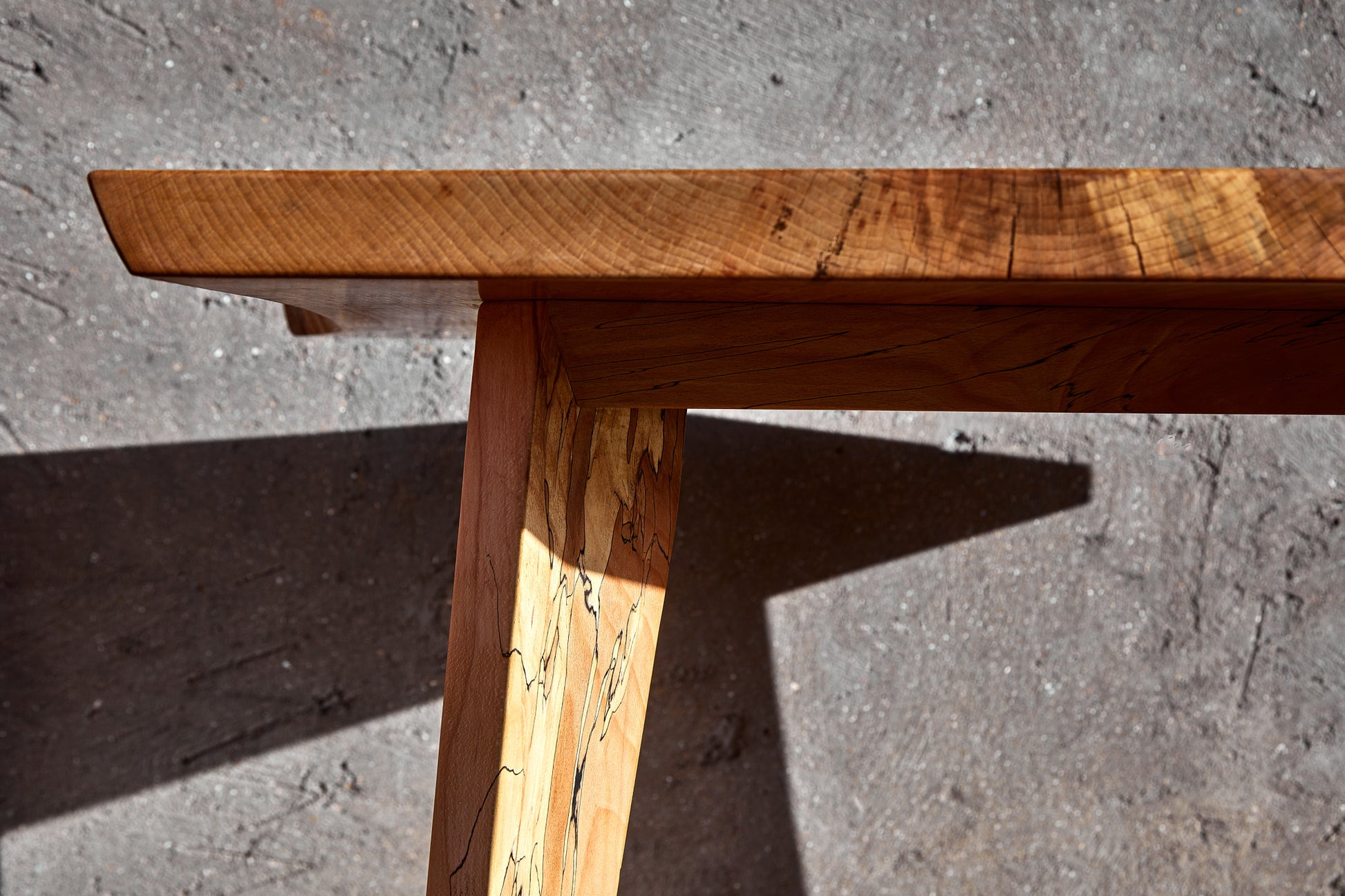 Meet the Moff Dining Table, a remarkable piece of Live Edge functional art. Fashioned from spalted beech, this natural edge table showcases an unparalleled detailed pattern. Its unique charm lies in the combination of mid-century modern legs and the meticulously book-matched tabletop, creating a solid wood dining table brimming with character. Finished with a natural wax coating, it exudes a lovely, radiant sheen. Prepare for this table to become the focal point of any room, offering years of enjoyment.