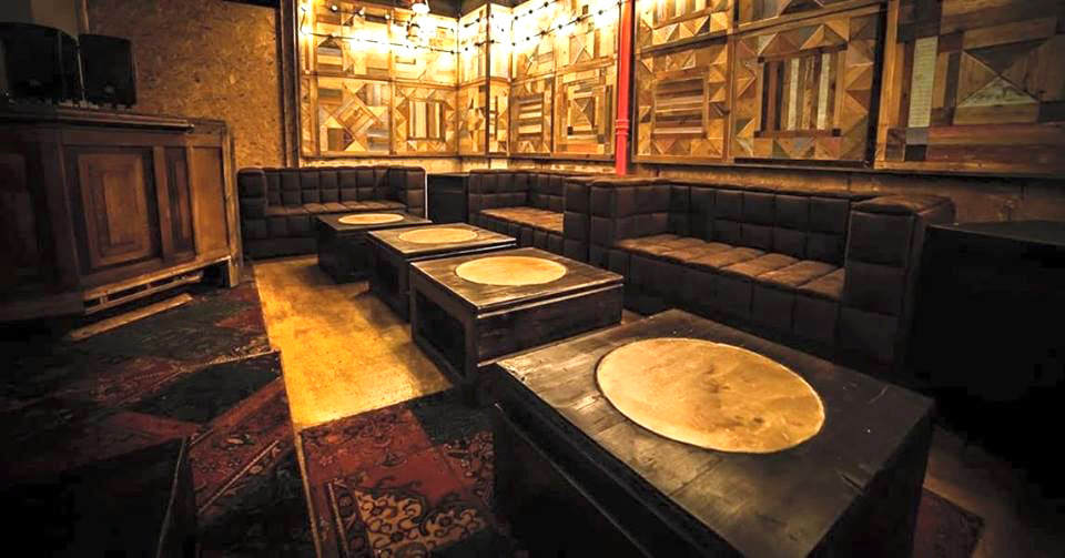 Live Edge Creations presents interior design and handmade wooden furniture installations at Cafe Kaizen. High quality pine wood for moon tables with circular marble accent.