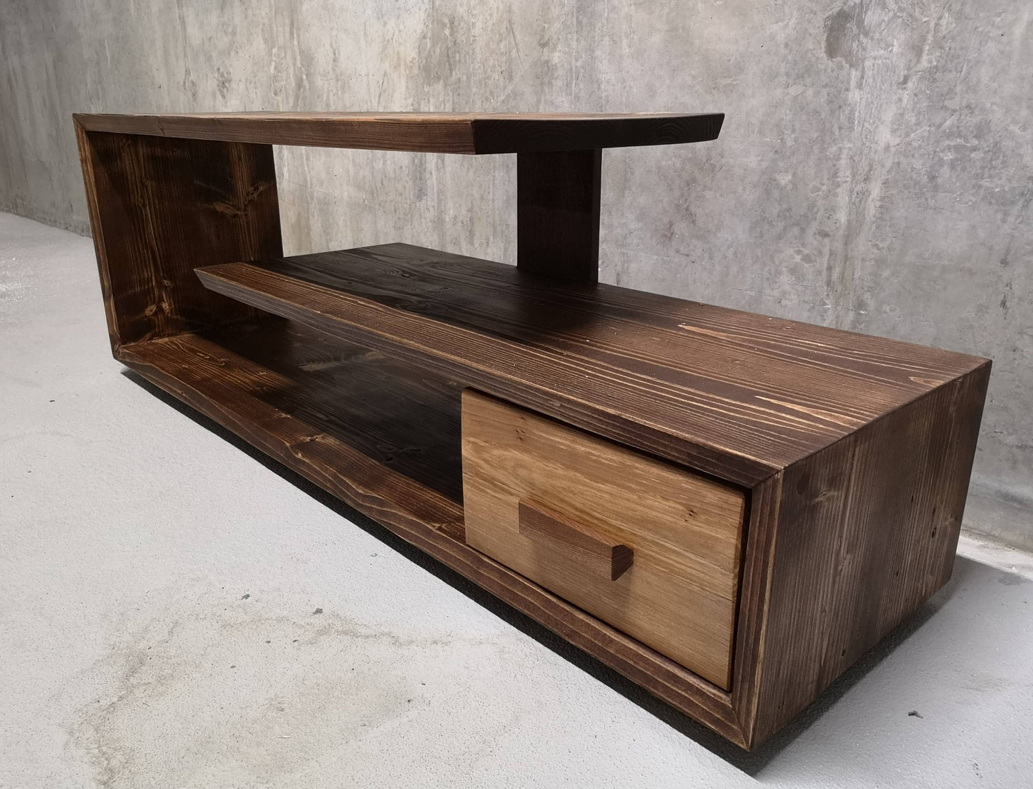 Discover Live Edge Creations' sophisticated and refined media unit, skillfully handcrafted from the richness of black walnut wood. Perfectly designed to declutter and arrange your entertainment essentials, this opulent TV cabinet will effortlessly enhance the visual appeal of your living room. Immerse yourself in its stylish presence, infusing rustic charm and timeless elegance into your space.